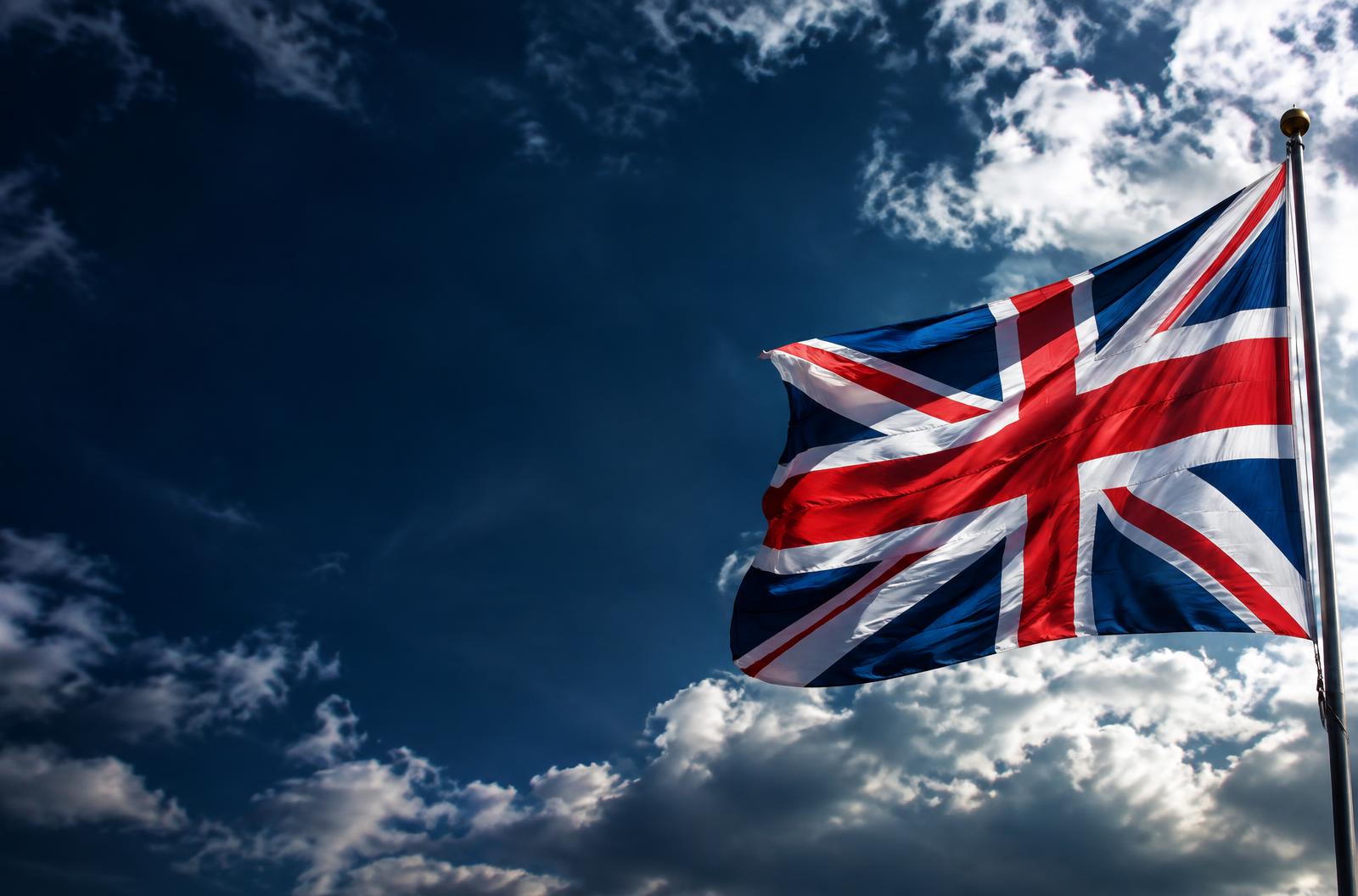Union Jack flying beneath a dramatic British sky